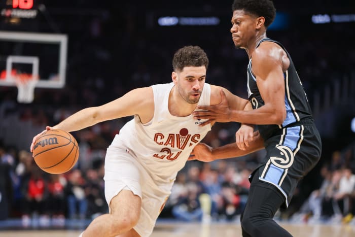 Mar 6, 2024; Atlanta, Georgia, USA; Cleveland Cavaliers forward Georges Niang (20) is defended by Atlanta Hawks forward De'Andre Hunter (12) in the second quarter at State Farm Arena.